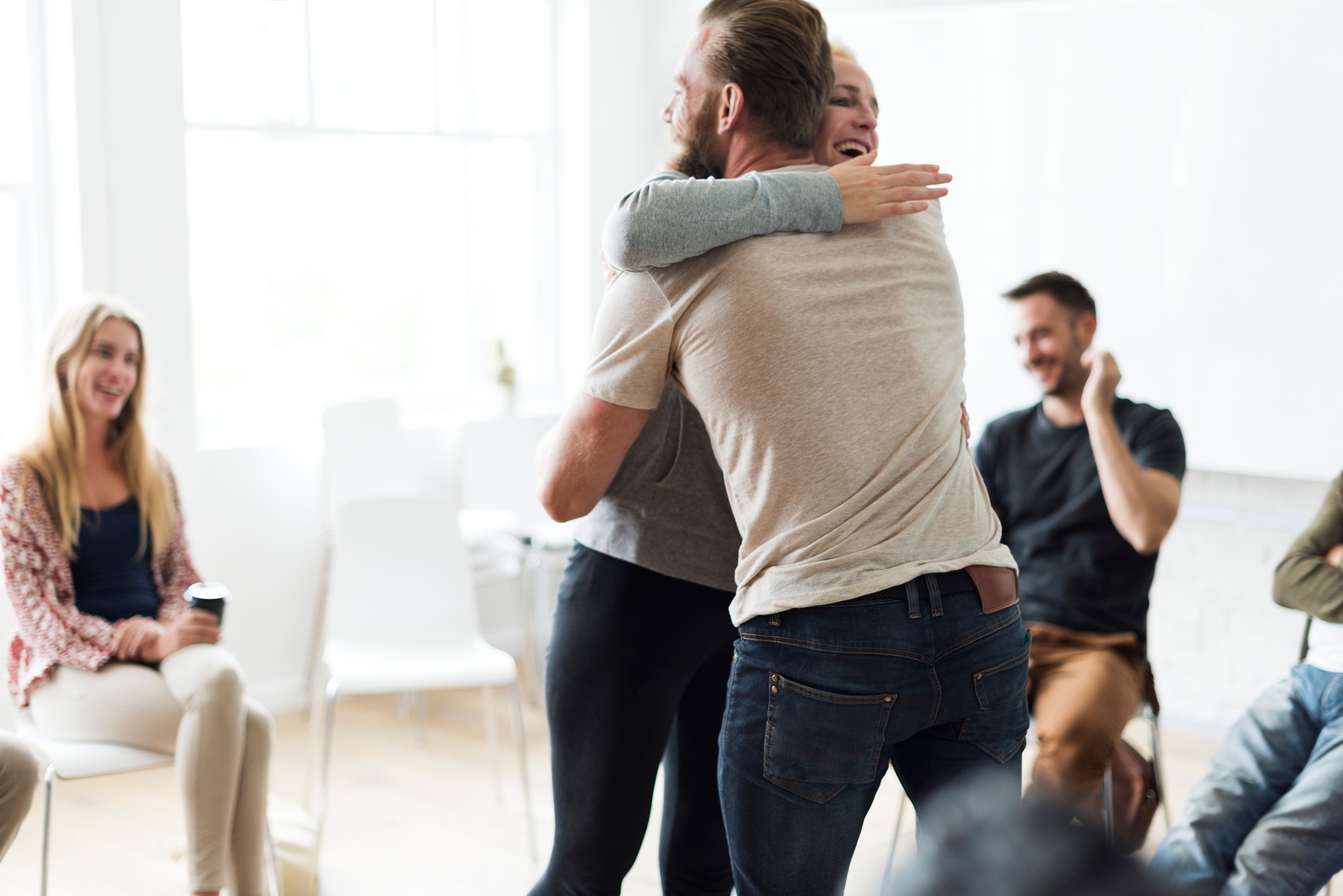 Home 6 Man and woman hugging in a support group